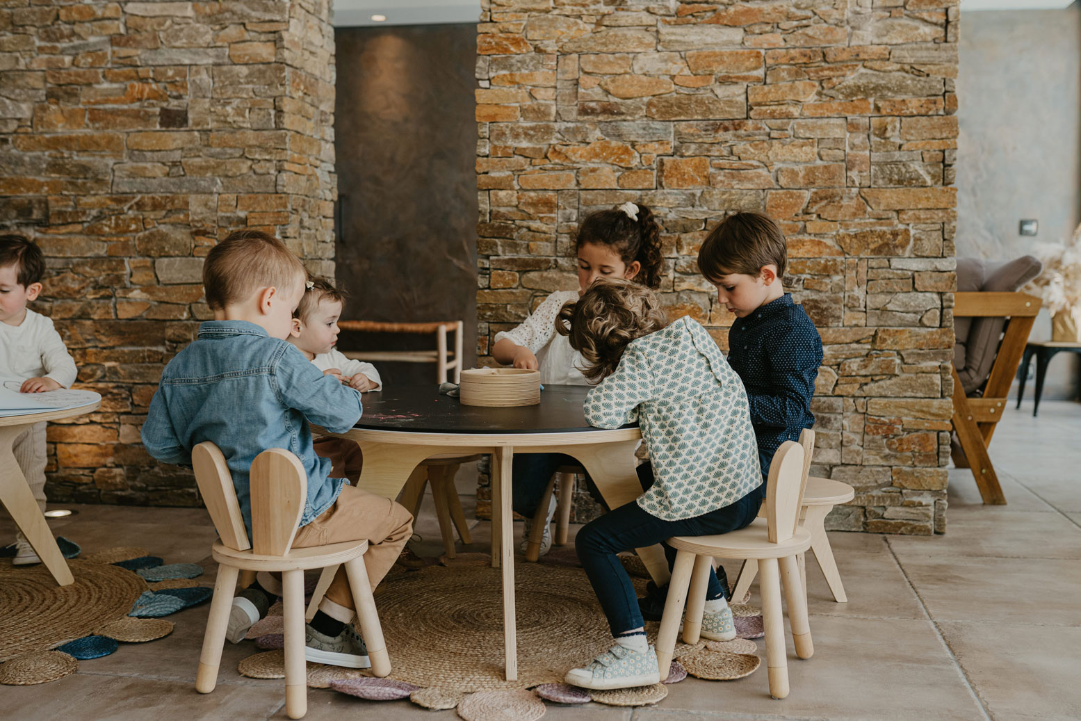 Children play on the Drawin'table, a stimulating piece of Montessori furniture