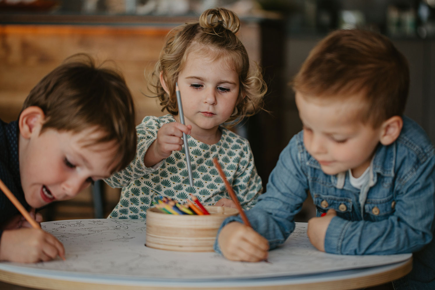 Children play on the Drawin'table, a stimulating piece of Montessori furniture