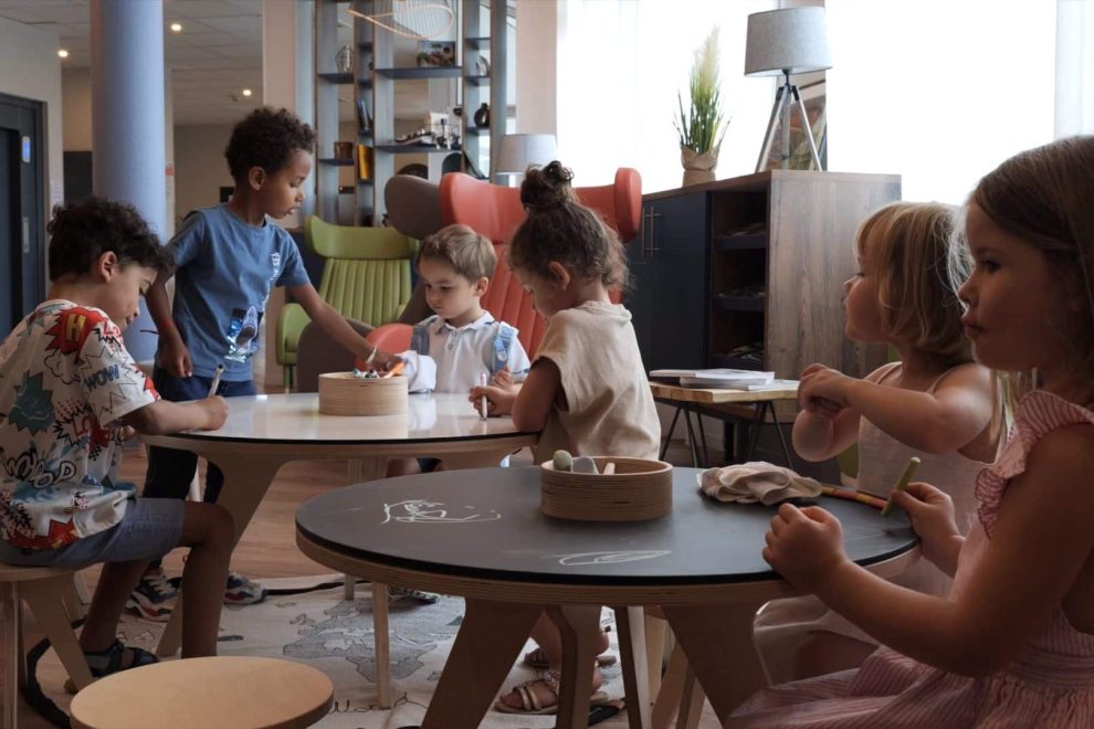 Children use the drawing table in a hotel
